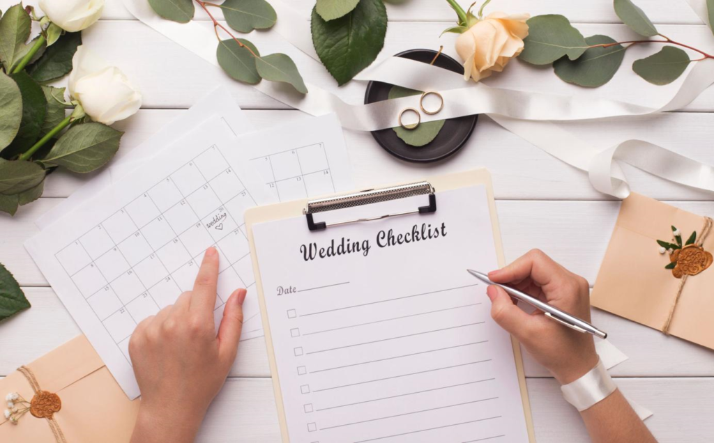 Mother of the bride organizing wedding plans using a planner notebook with checklist, budget notes, and coffee